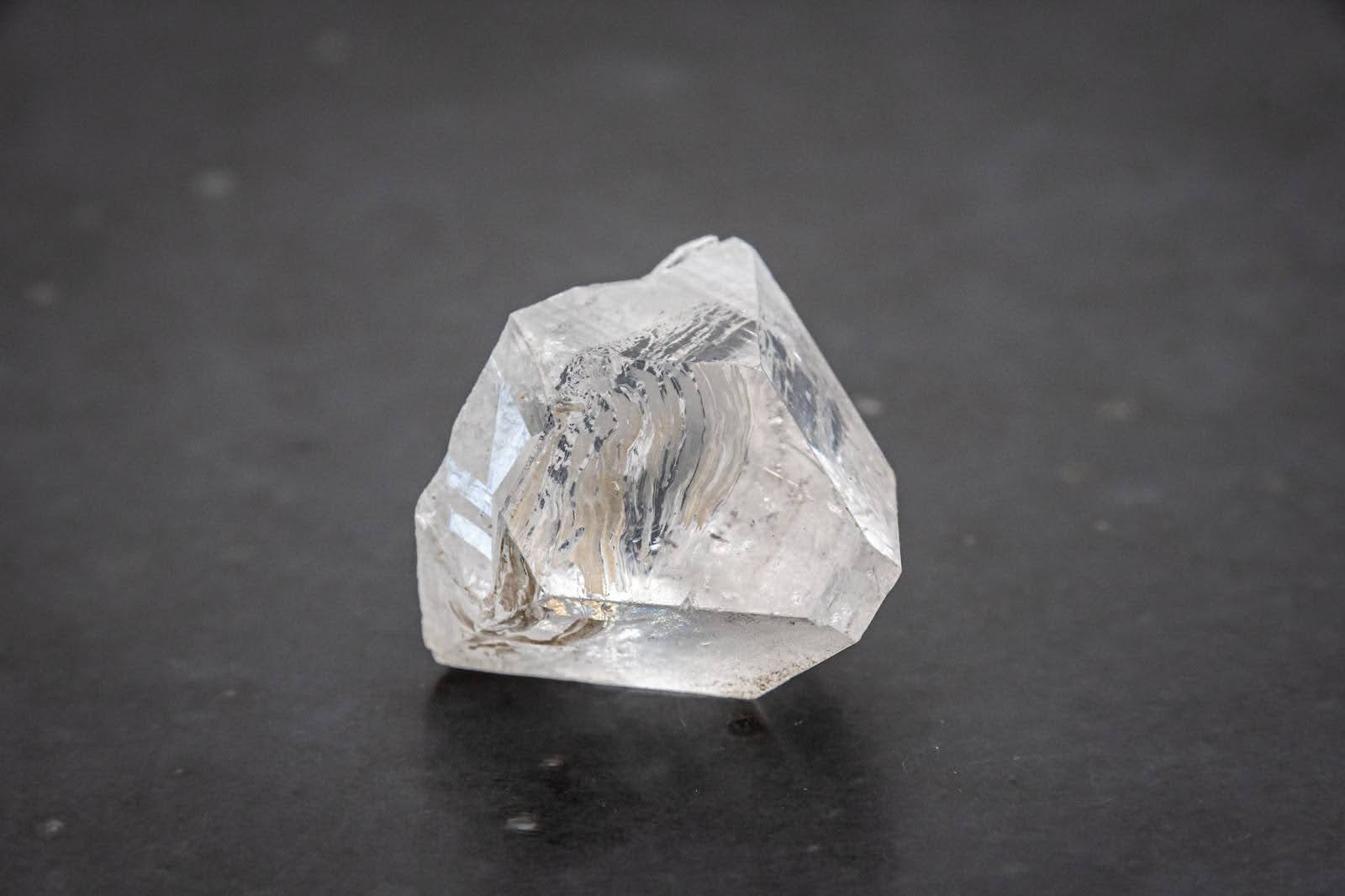 Raw diamond against a dark background