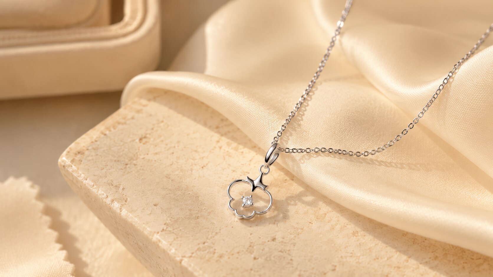 Raw diamond necklace on cream stone and silk fabric
