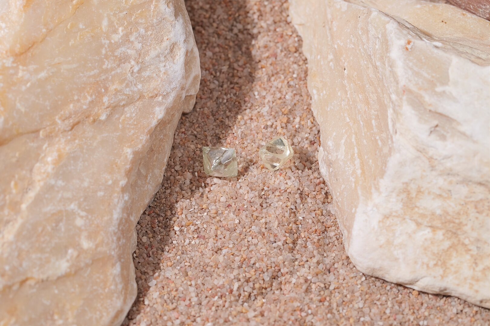two natural rough diamonds showing octahedral crystal shapes.