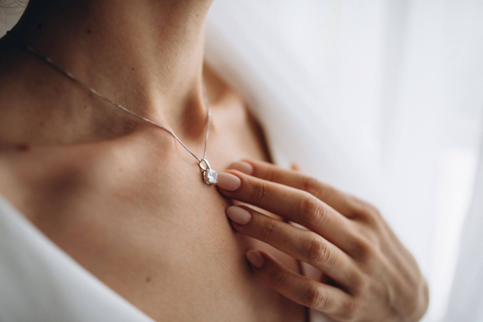 A woman wearing a diamond pendant